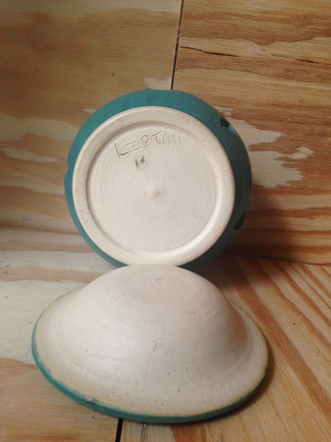 Teal melted wax warmer with hand cut out leaf pattern.