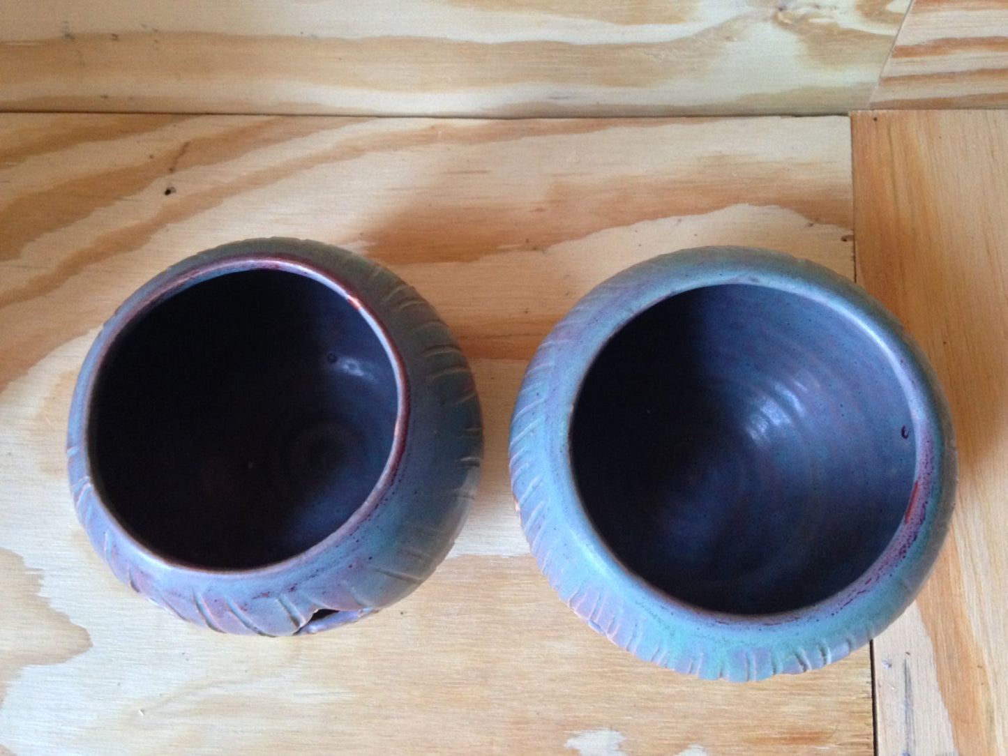 Green and red ceramic candle holder with carved pumpkin design