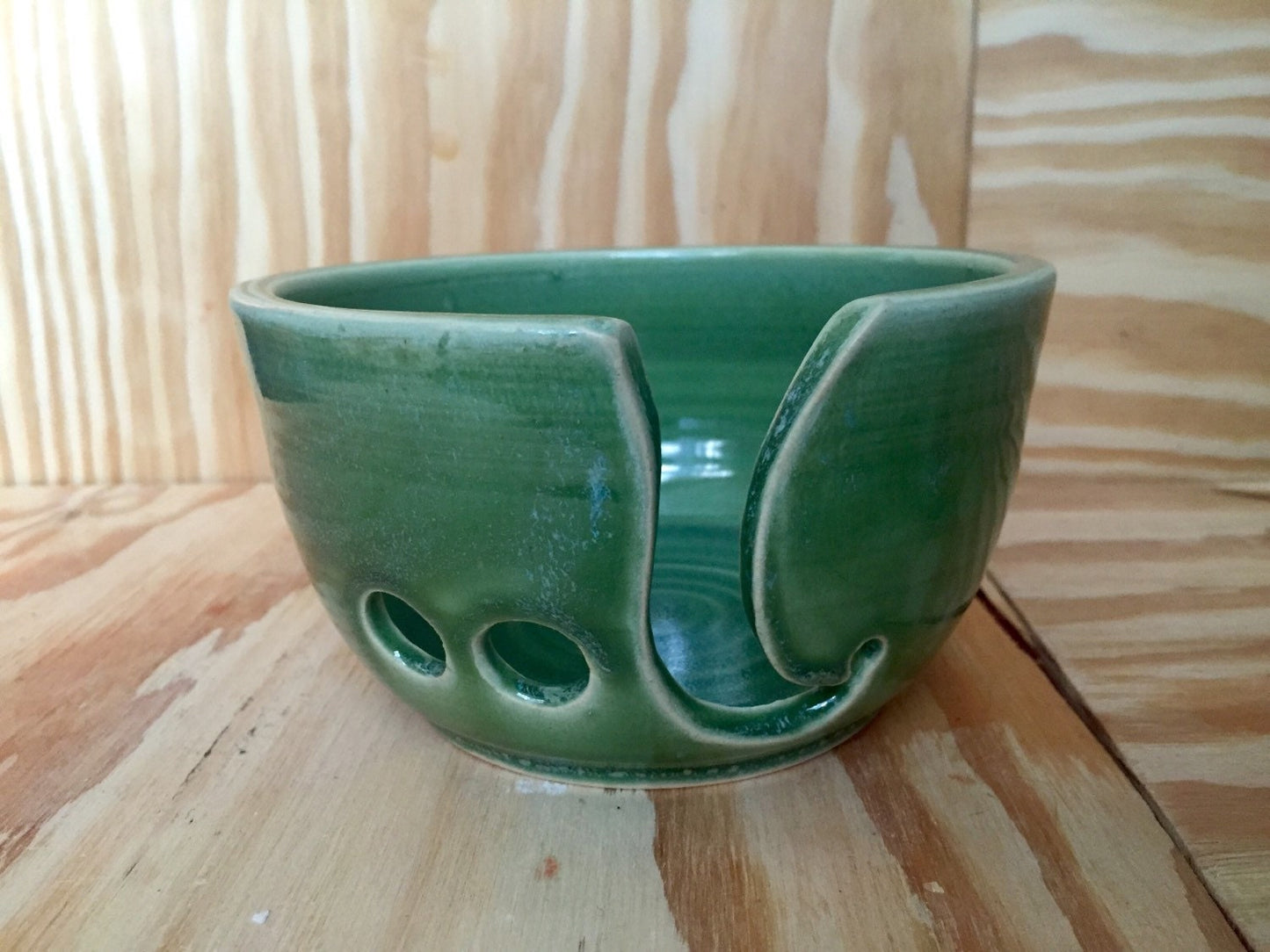 Hand crafted green ceramic knitting yarn bowl with hand cut pattern