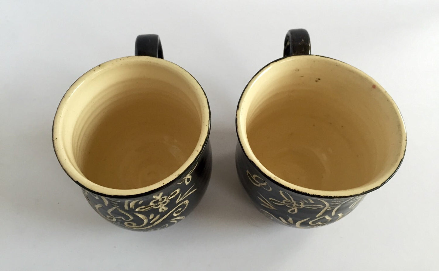 Sugar skull black ceramic coffee mugs with sgrafitto design set of two.