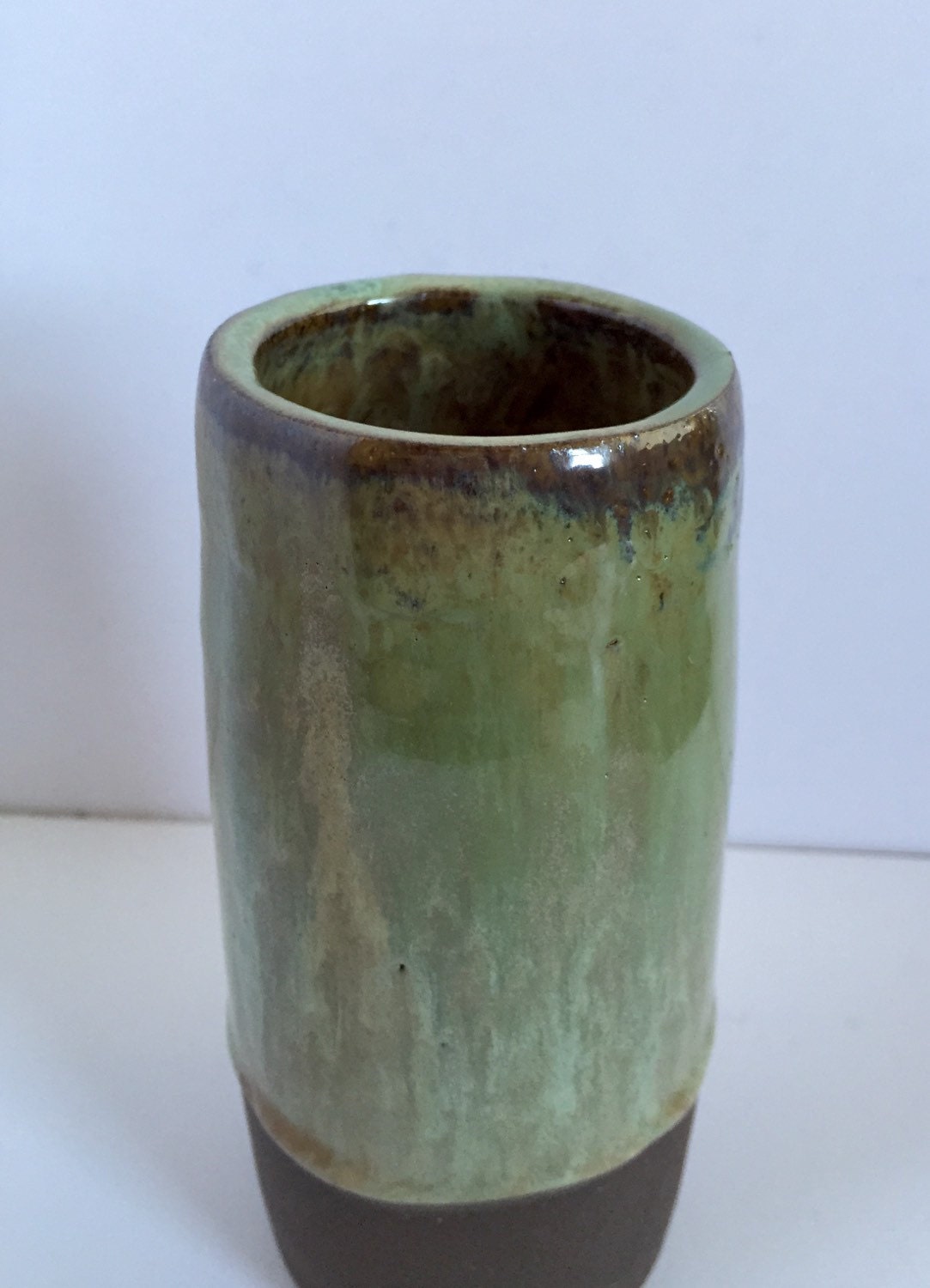 Tall Ceramic flower vase with blue/green glaze.