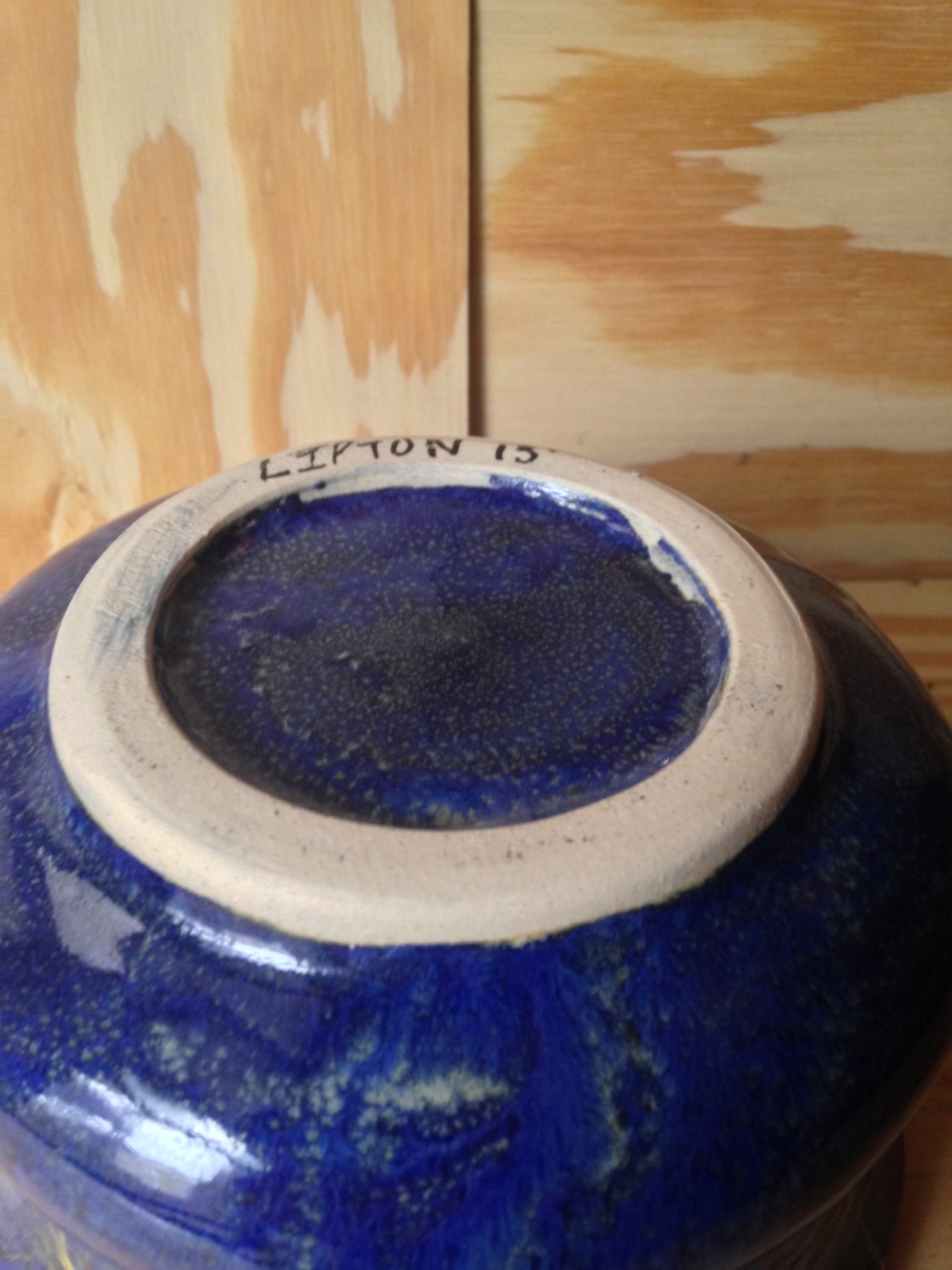 beautiful medium sized bowl in colbalt blue with a waxed in yellow star pattern