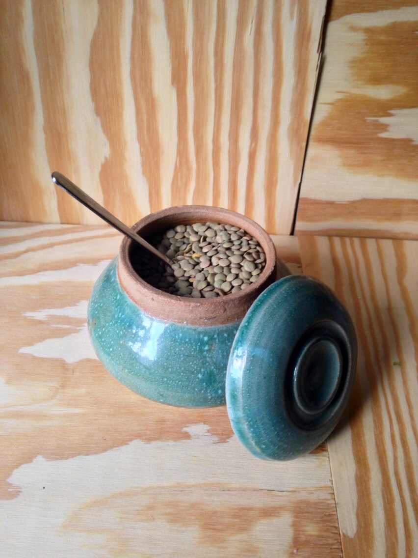 Multipurpose functional hand thrown turquoise lidded jar.
