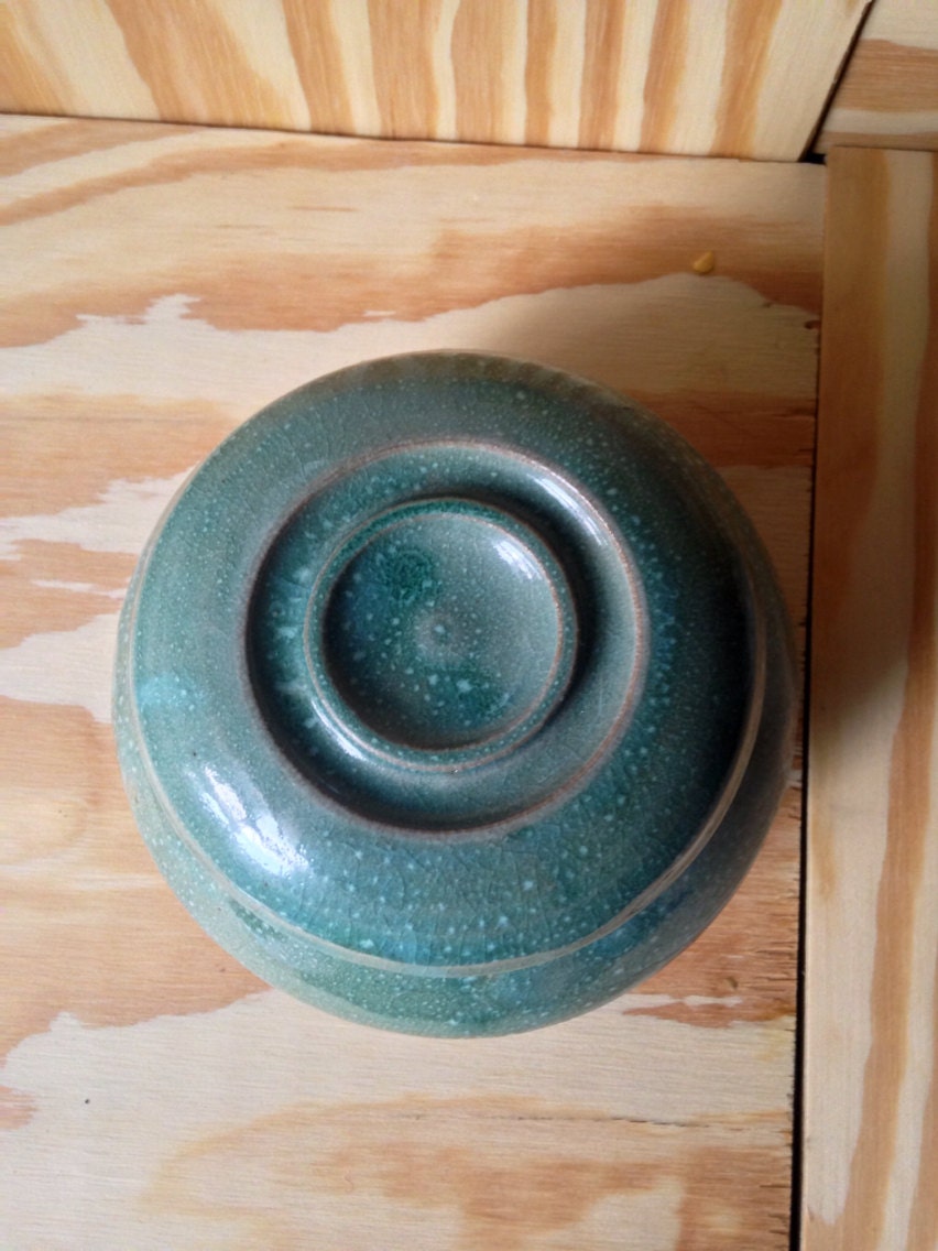 Multipurpose functional hand thrown turquoise lidded jar.