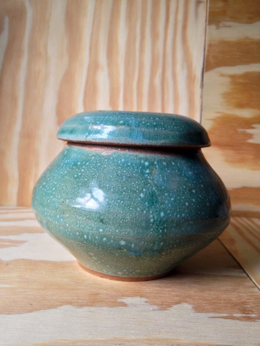 Multipurpose functional hand thrown turquoise lidded jar.