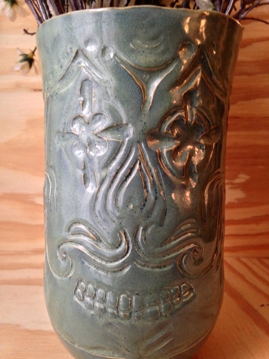 Unique blue green ceramic vase with sugarskull carving