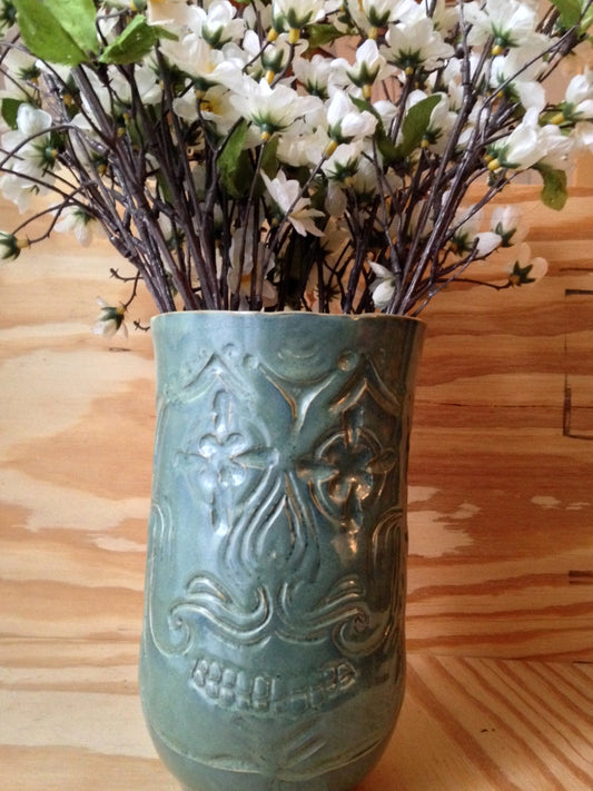 Unique blue green ceramic vase with sugarskull carving