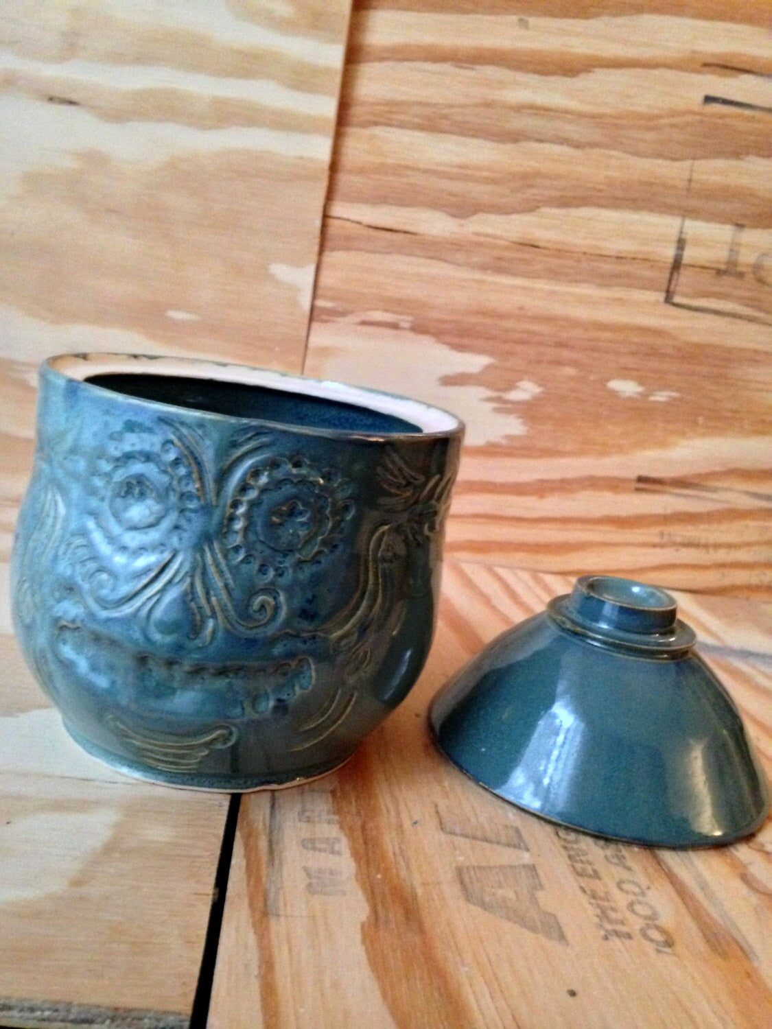 blue green medium sized lidded ceramic jar with free hand sugar skull carving