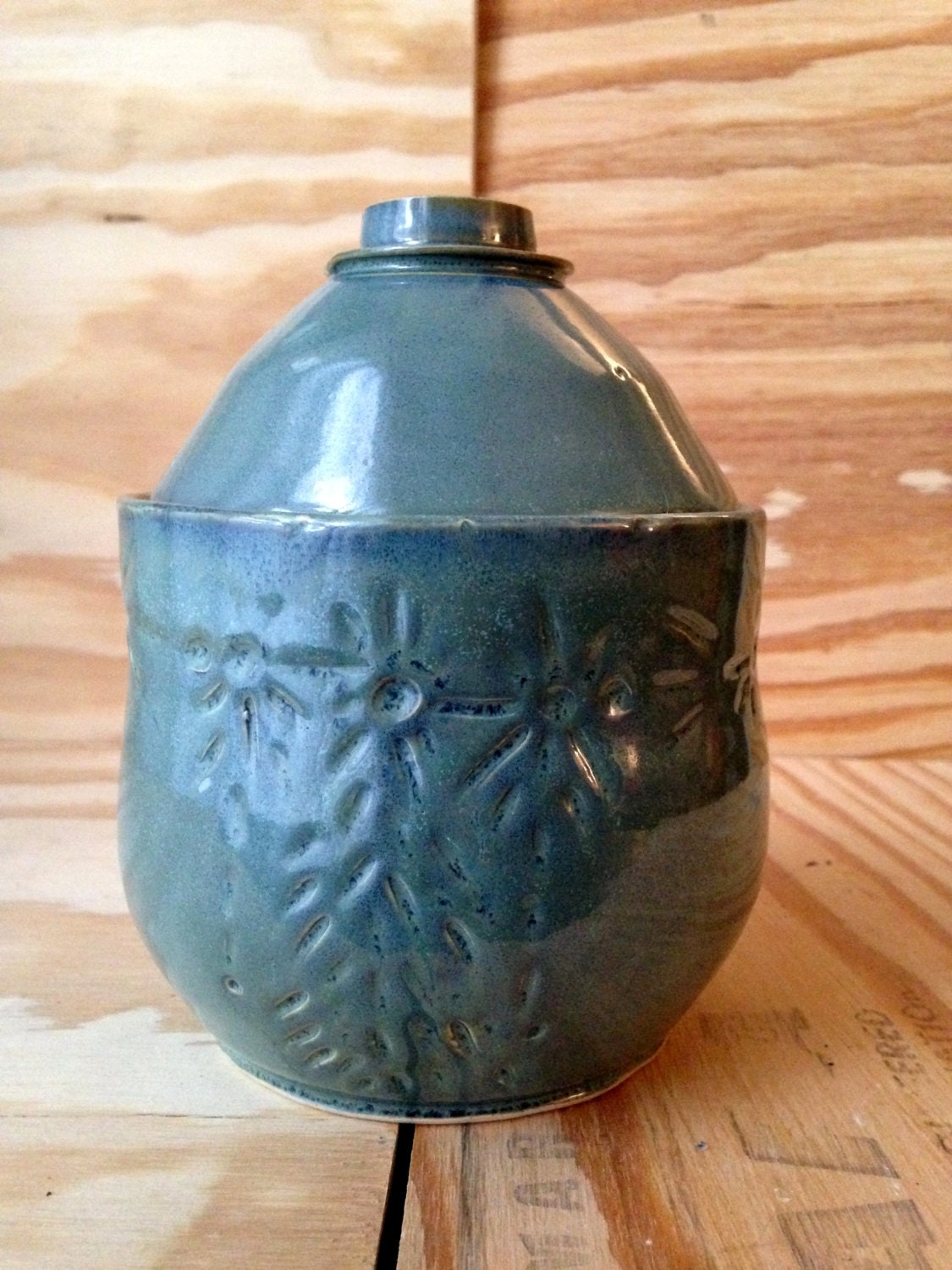 blue green medium sized lidded ceramic jar with free hand sugar skull carving