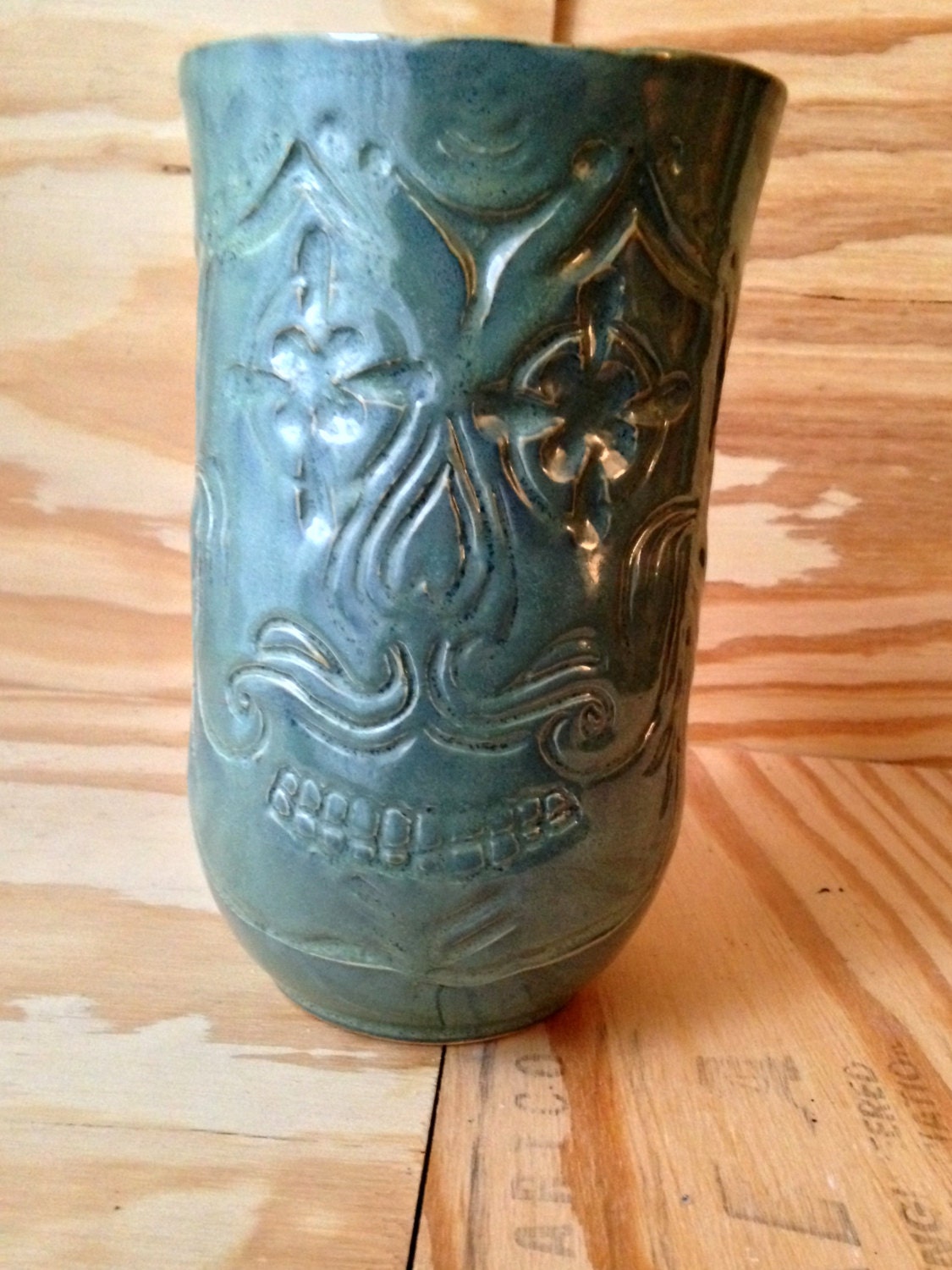 Unique blue green ceramic vase with sugarskull carving