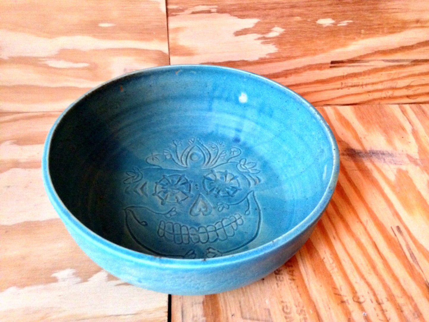 Large turquiose ceramic bowl with freehand sugar-skull carving