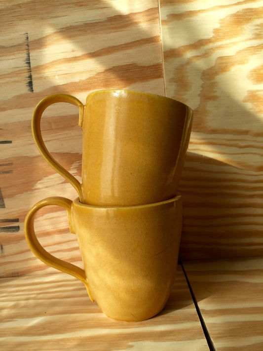 Set of two hand made ceramic coffee mugs in warm daffodil yellow