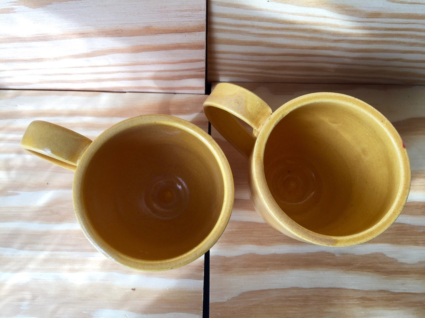 Set of two hand made ceramic coffee mugs in warm daffodil yellow