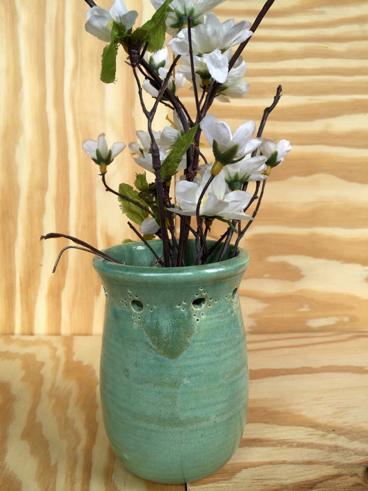 Handmade ceramic bud vase with flower cut out in mint green