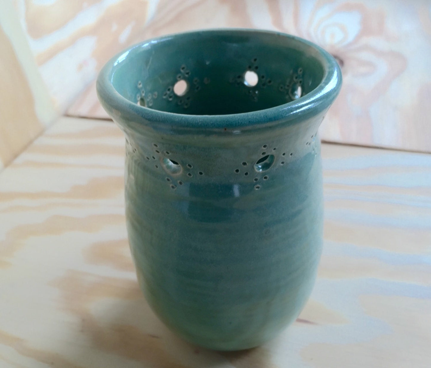 Handmade ceramic bud vase with flower cut out in mint green