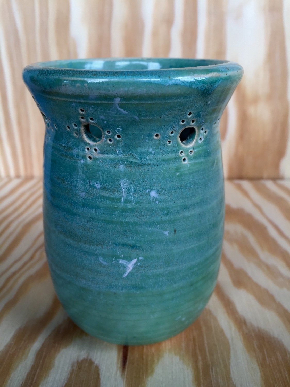 Handmade ceramic bud vase with flower cut out in mint green