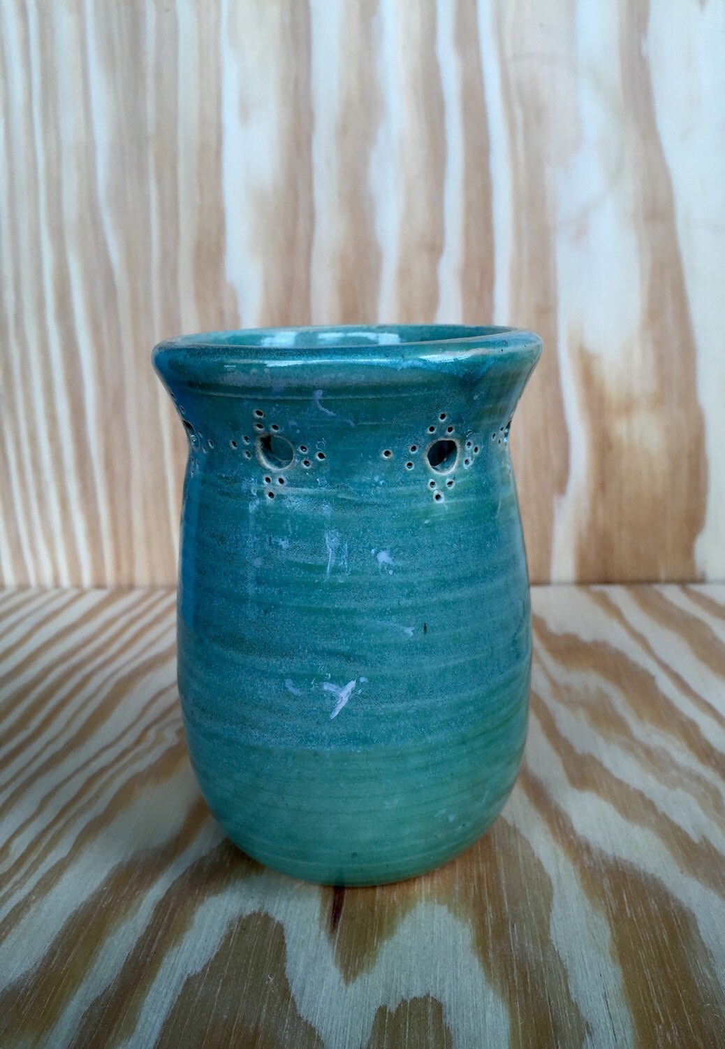 Handmade ceramic bud vase with flower cut out in mint green