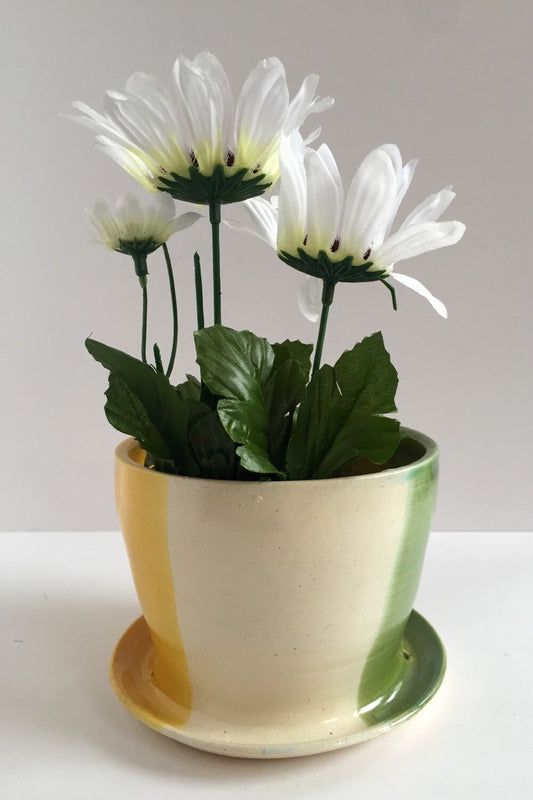 ceramic planter with attached base in green yellow and white