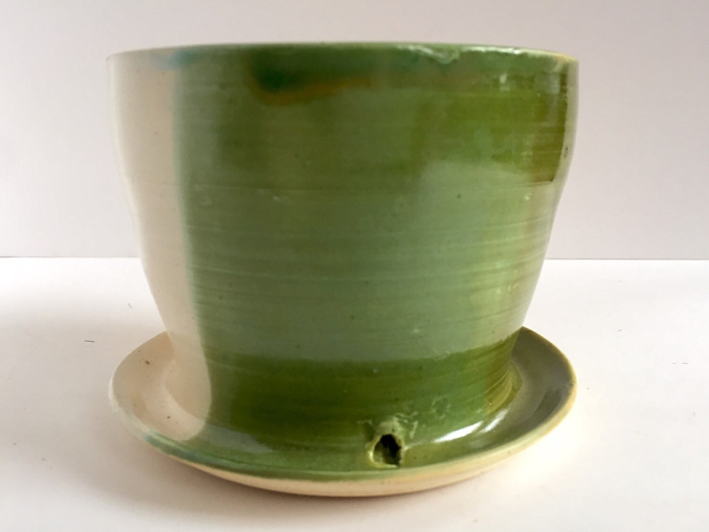 ceramic planter with attached base in green yellow and white