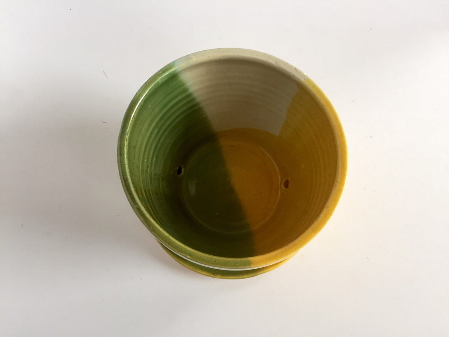 ceramic planter with attached base in green yellow and white