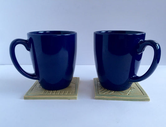ceramic green coaster set of two with hand carved design