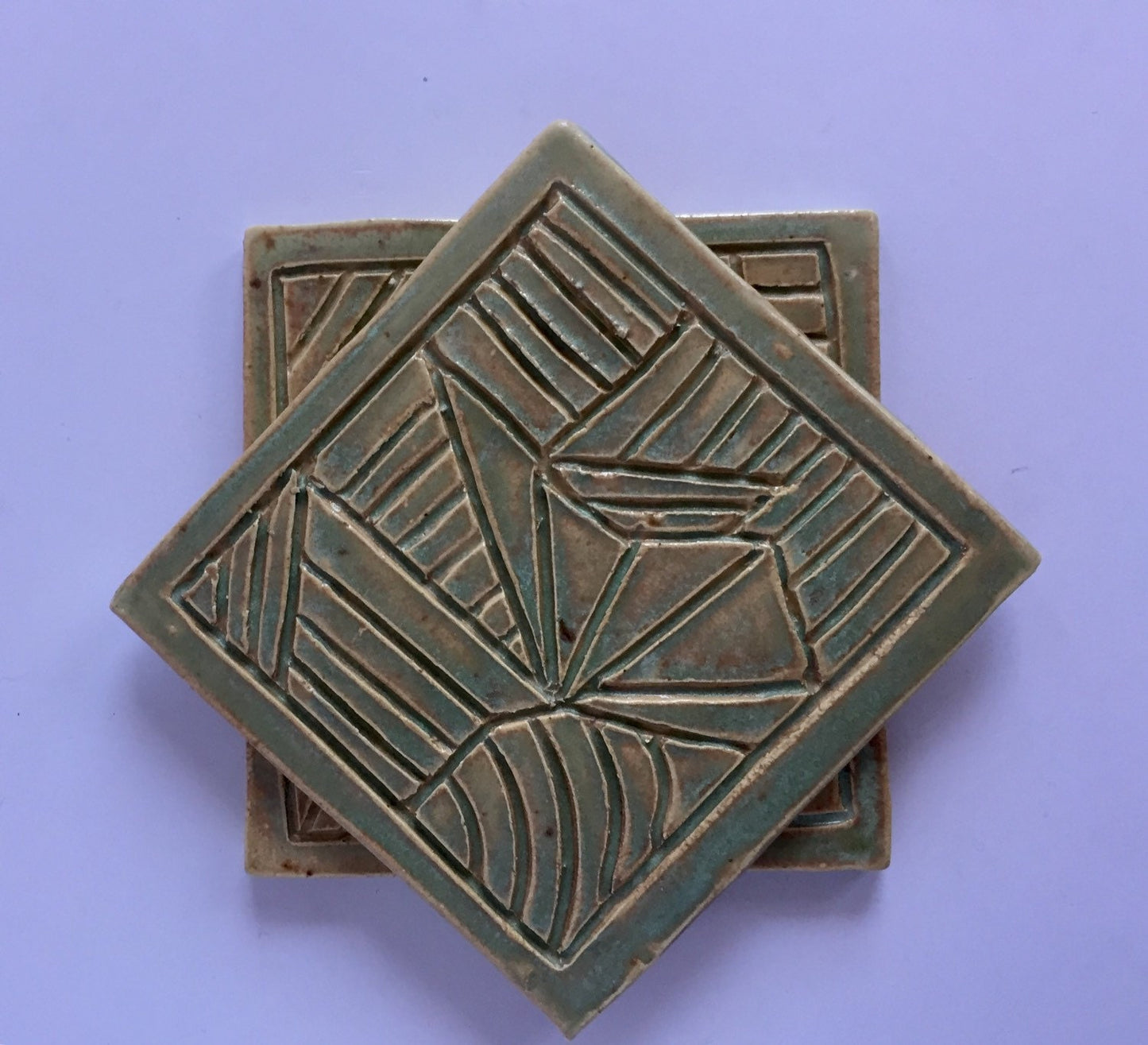 ceramic green coaster set of two with hand carved design