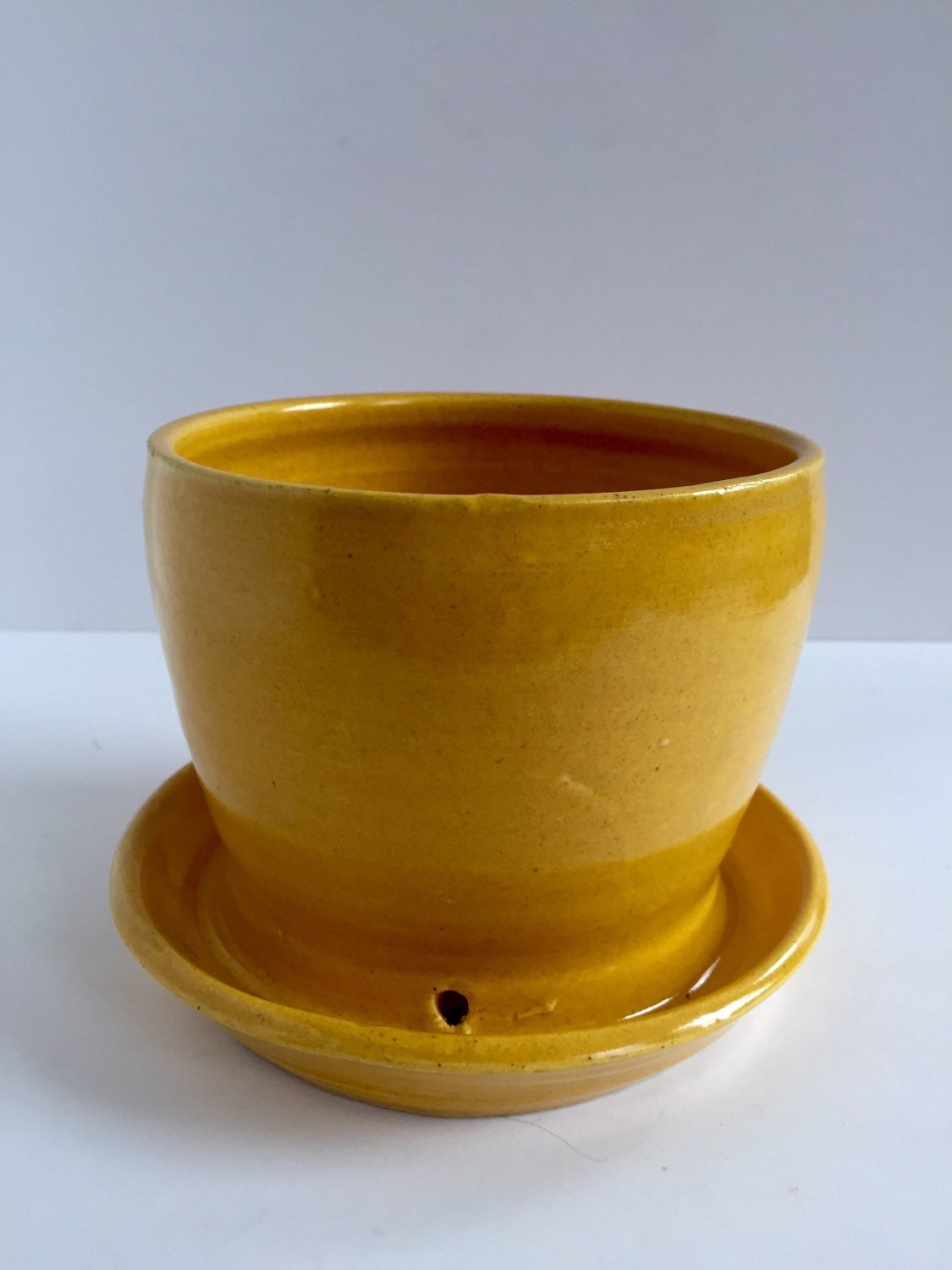 yellow ceramic planter with attached base