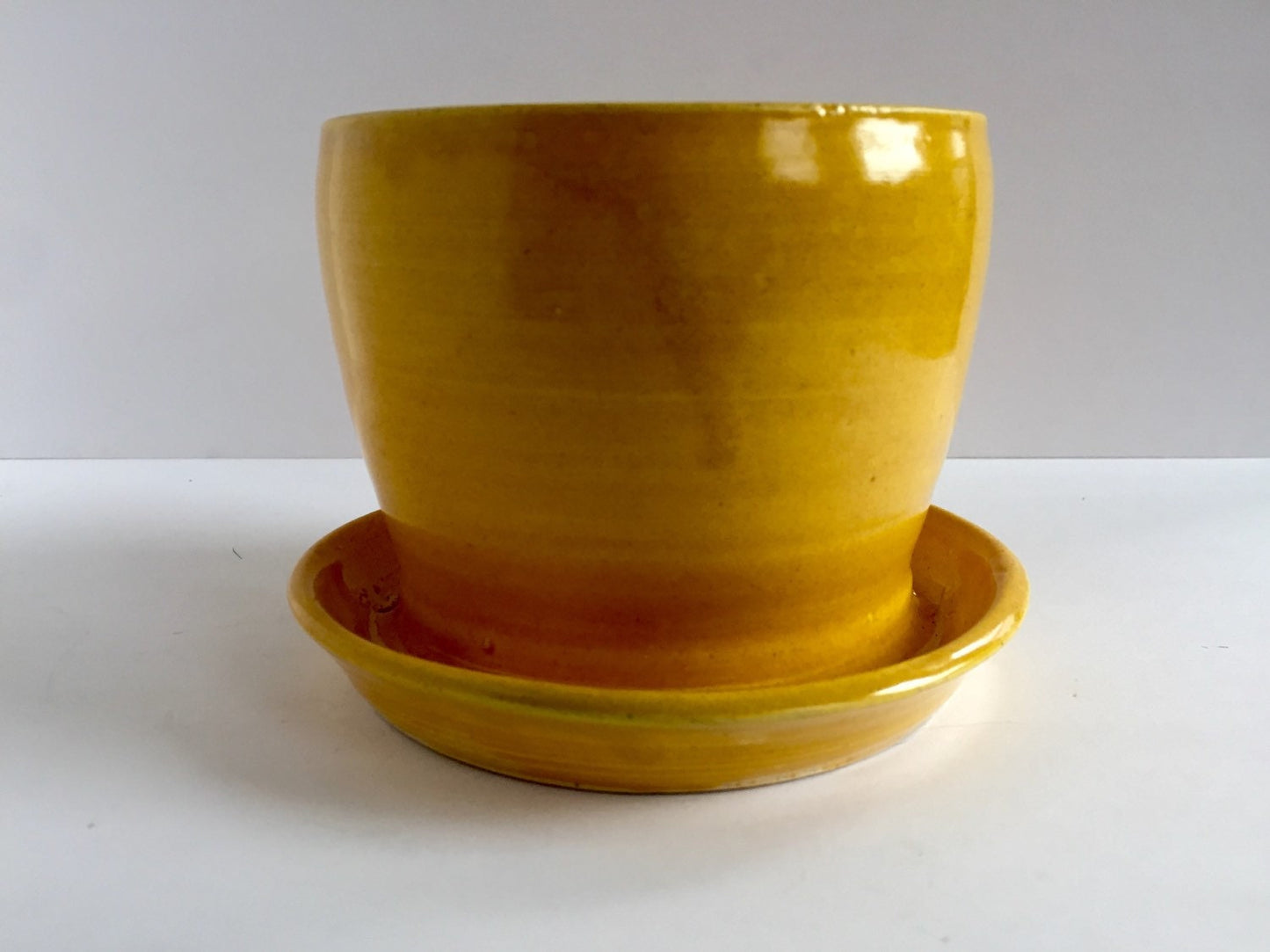 yellow ceramic planter with attached base