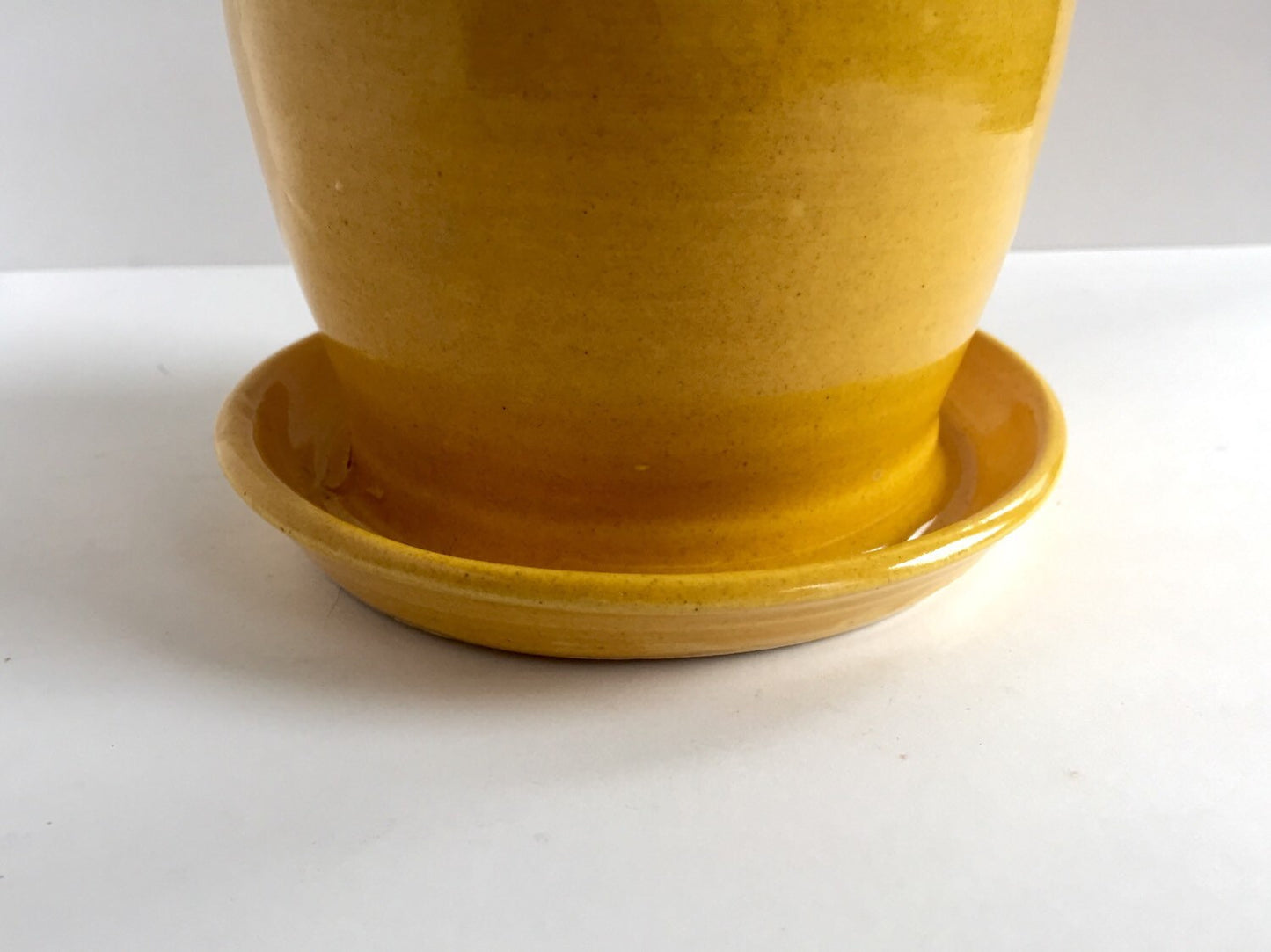 yellow ceramic planter with attached base