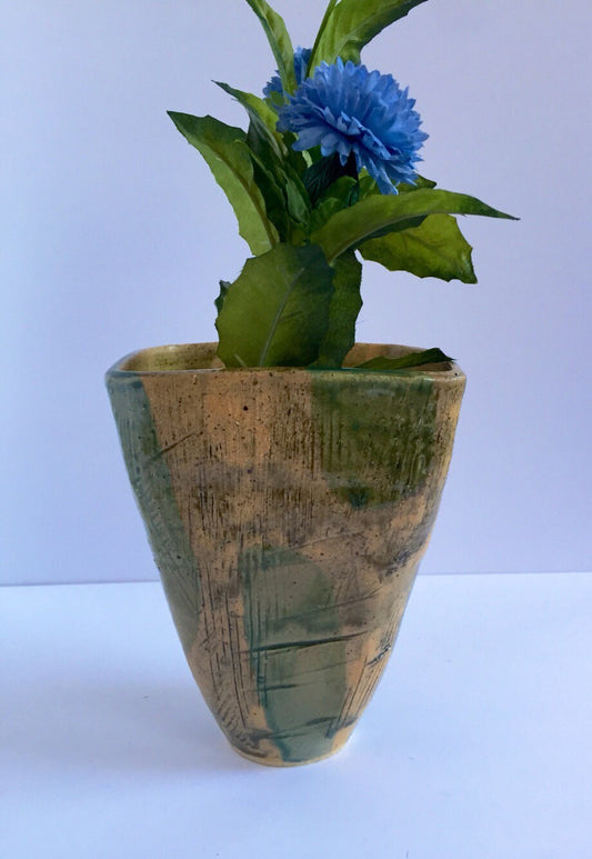 green vase ceramic with textured markings and square shape.