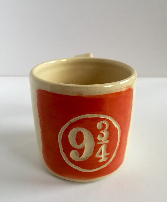 Orange Ceramic mug with "9 and 3/4" platform sumbol inspired by harry potter