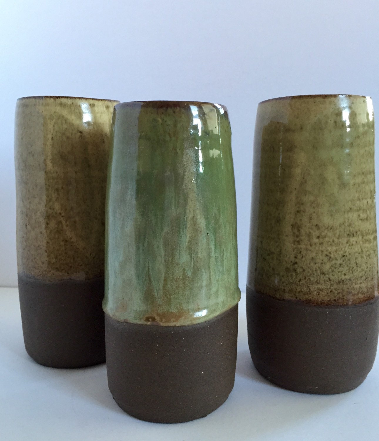 Tall Ceramic flower vase with blue/green glaze.