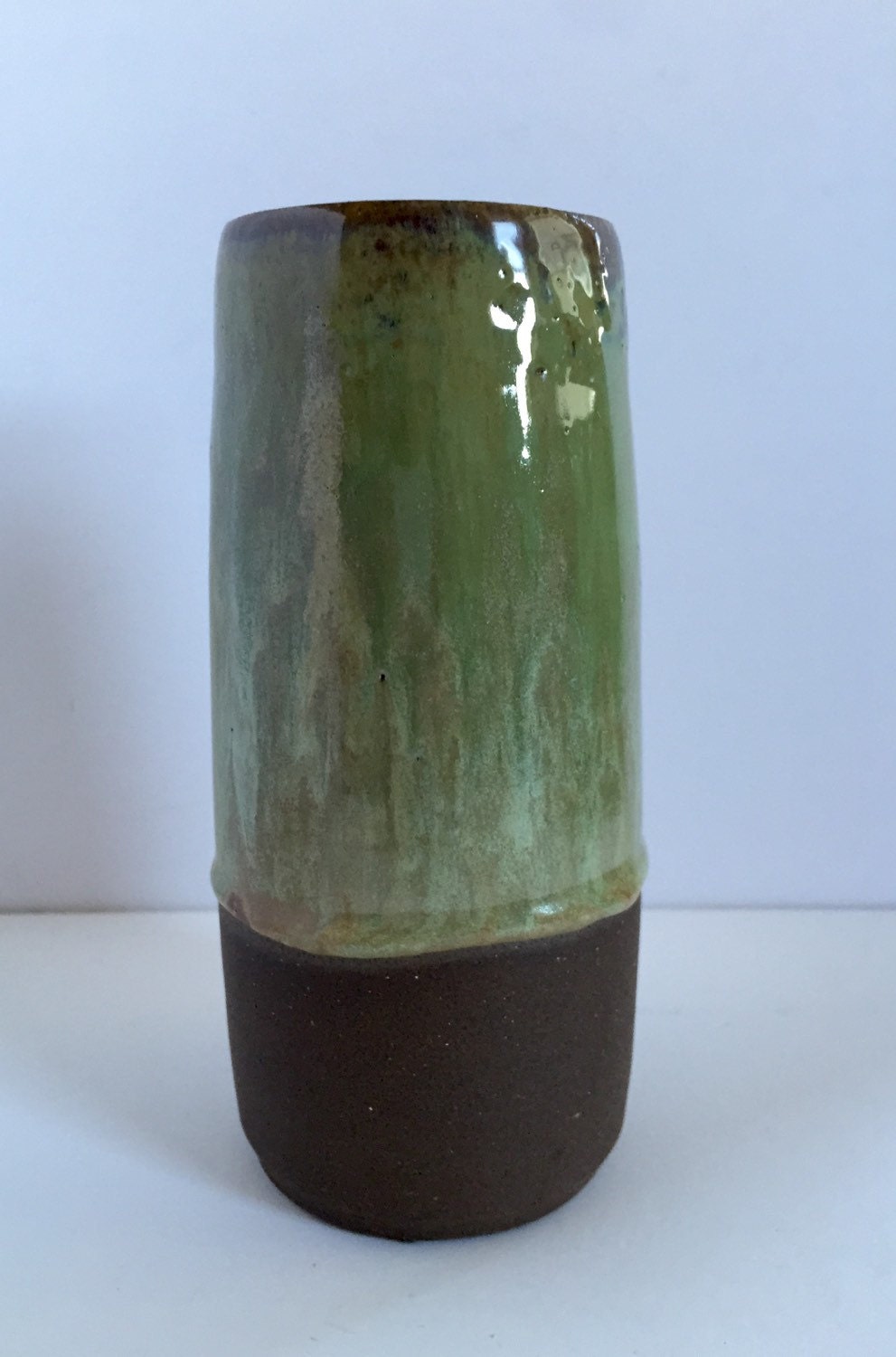 Tall Ceramic flower vase with blue/green glaze.