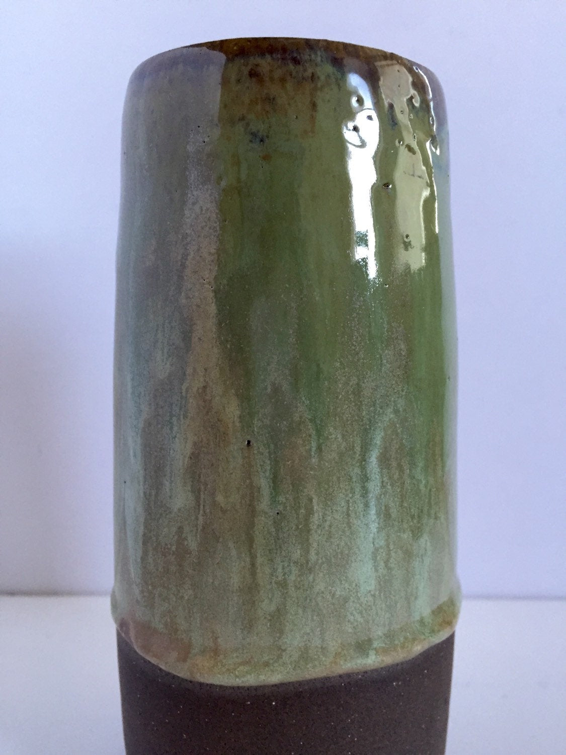 Tall Ceramic flower vase with blue/green glaze.