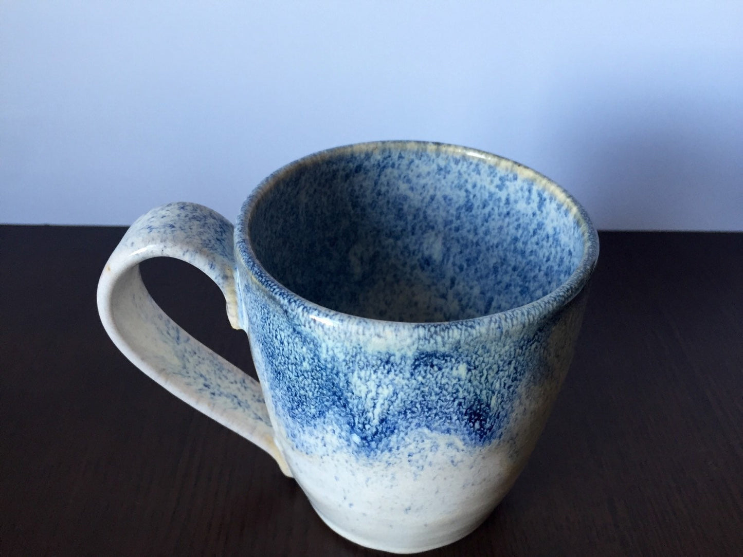 Ceramic coffee mug in white and blue snow fall.