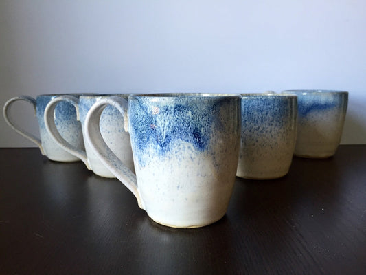 Ceramic coffee mug in white and blue snow fall.