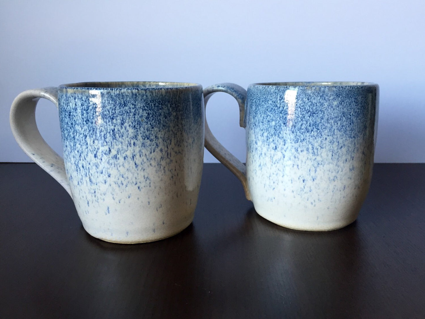 Ceramic coffee mug in white and blue snow fall.